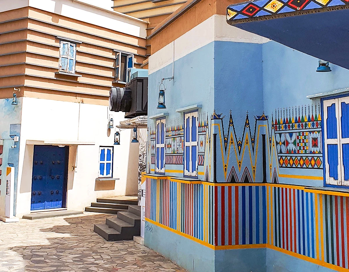 Painted walls along a street in Al Muftaha Art Village