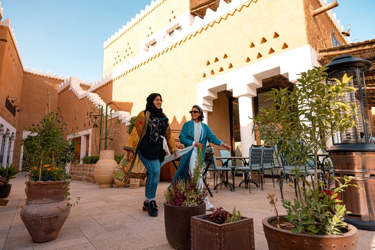 Women walking through Bujairi Terrace in Diriyah together. STA
